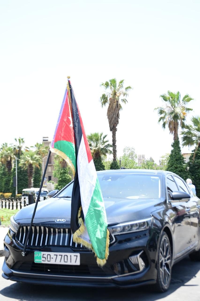 Black Kia sedan with Jordanian flag for official occasions